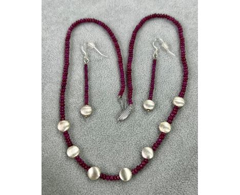 A modern 9ct white gold ruby bead necklace, together with matching earrings.