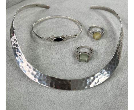 A modern 'hammered' silver open back torque necklace, together with silver and black stone bangle etc.