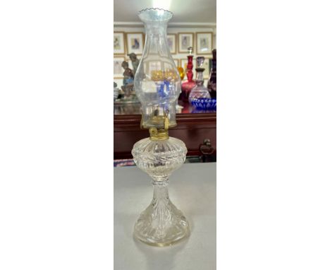 A clear glass oil lamp, height 40cm.