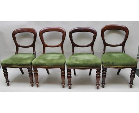 A SET OF FOUR VICTORIAN MAHOGANY BALLOON BACK DINING CHAIRS having serpentine stuff over seats, on ring turned fore supports 