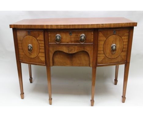 A REGENCY DESIGN MAHOGANY BOW FRONTED SIDEBOARD, having crossbanded top, over a base with fitted drawers flanked by cupboards