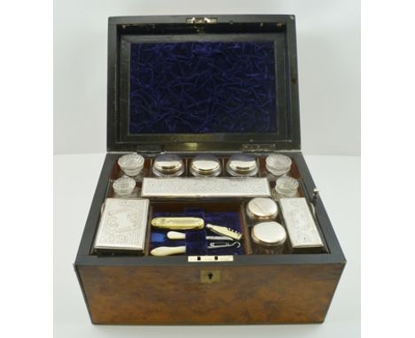 A LATE 19TH CENTURY WALNUT VENEERED TRAVELLING VANITY CASE, brass mounted, the cover inset with an engraved brass presentatio