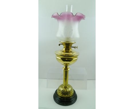 A BRASS OIL LAMP raised on fluted column, fitted Duplex mechanism with etched pink tinted rim, shade and chimney, 43cm high (
