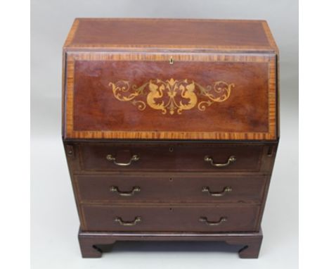 AN EDWARDIAN MAHOGANY FALLFRONT WRITING BUREAU, decoratively inlaid, fitted interior, over three drawers to base with brass h