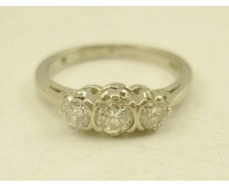 A PLATINUM RING set with central diamond flanked by a a pair of smaller stones, size M 