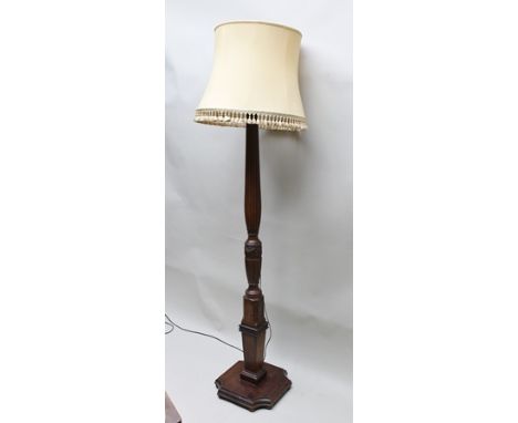 A STANDARD LAMP, formed from a 19th century mahogany bed post, of fluted form with carved swag knop, raised on squared plinth