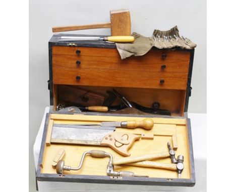 A CABINET MAKERS OWN MADE EBONISED TOOL BOX, the hinged front reveals a tool store and three drawers containing various woodw