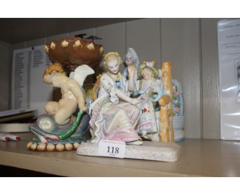 A continental porcelain posy holder, in the form of a boy with barrel and grape hod; two continental porcelain figures; and a