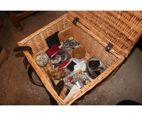 A wicker basket containing a glass paperweight; a 19th Century snuff box; costume jewellery; a silver plated spot hammered bo