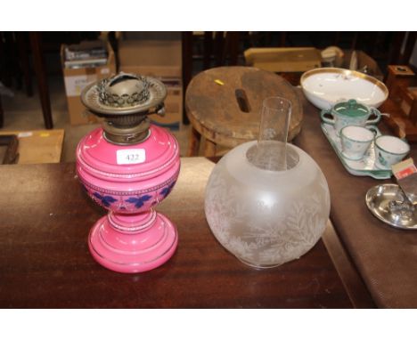 A Victorian pink glass oil lamp with etched glass shade