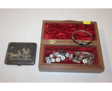 A box containing Eastern silver and Niello decorated jewellery to include a bangle, brooch, cuff-links, bracelet, and a cigar