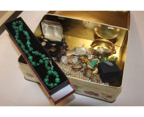 A tin of costume jewellery, a bangle, wrist watch etc.