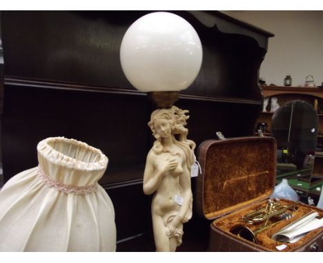 Figural table lamp with globe shade