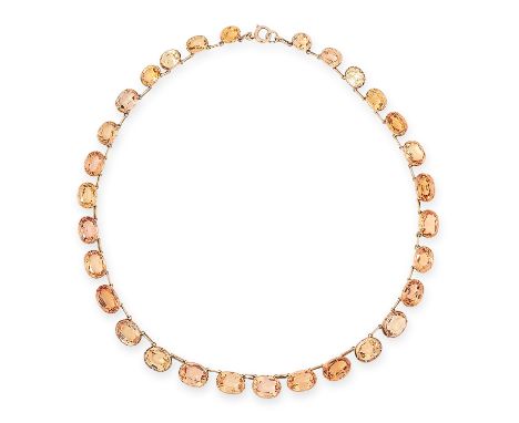 AN ANTIQUE IMPERIAL TOPAZ RIVIERE NECKLACE, 19TH CENTURY in yellow gold, comprising of thirty oval cut imperial topaz totalli