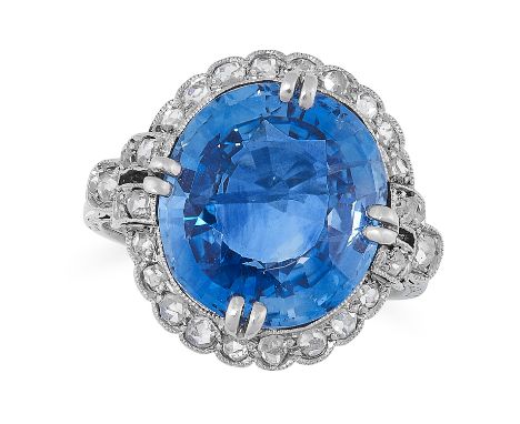 AN ART DECO SAPPHIRE AND DIAMOND RING in 18ct white gold and platinum, set with an oval cut sapphire of 9.67 carats within a 