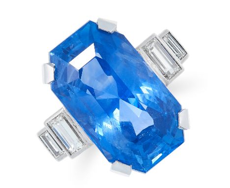 A 21.36 CARAT CEYLON NO HEAT SAPPHIRE AND DIAMOND RING in platinum, set with an emerald cut sapphire of 21.36 carats between 