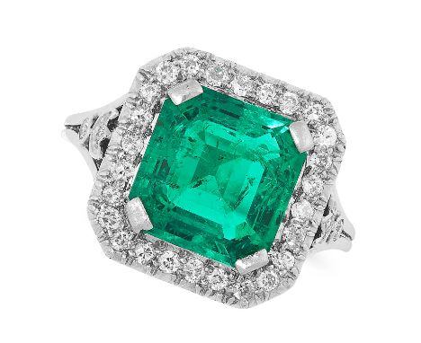 A COLOMBIAN EMERALD AND DIAMOND CLUSTER RING set with an emerald cut emerald of 2.84 carats in a cluster of round cut diamond