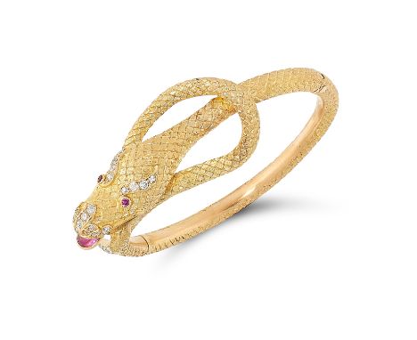 A RUBY AND DIAMOND SNAKE BANGLE in the form of a snake coiled around itself set with round cut diamonds, rubies and a cabocho