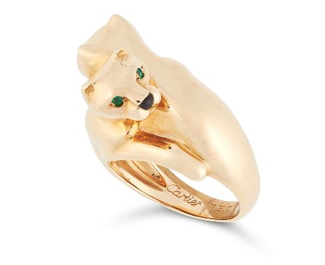 AN EMERALD AND ONYX DOUBLE PANTHER RING, CARTIER in 18ct yellow gold, designed as two interlocking panthers set with round cu