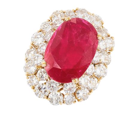 A 10.90 CARAT BURMA NO HEAT RUBY AND DIAMOND CLUSTER RING in 18ct yellow gold, comprising of an oval cut ruby of 10.90 carats