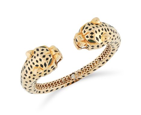 AN ENAMEL AND TOURMALINE DOUBLE PANTHER BANGLE in the style of Cartier Panthere, in the form of two panthers heads set with b