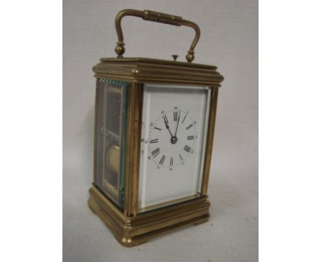 A large gilt brass framed French Carriage clock, five bevelled glass panes, white enamelled face with Roman and Arabic numera