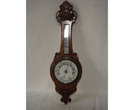 A good carved oak Aneroid Barometer of typical Banjo form, thermometer to neck, 90cm high