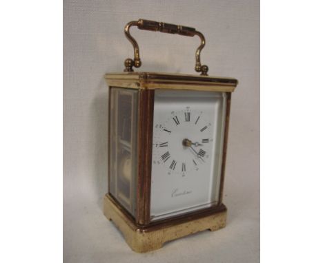 A large gilt brass framed French carriage clock, five bevelled glass panes, white enamelled face with Roman numerals, signed 