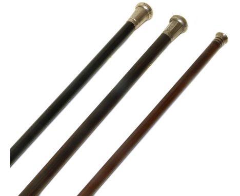 Three silver-topped walking canes, each with engine turned decoration, one stick with replacement wooden shaft (3).