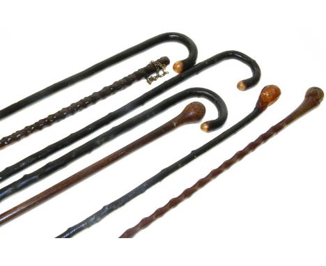 Three traditional black varnished walking canes, one other stick with turned handle and three hardwood walking canes (7).