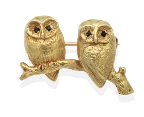 An 18 Carat Gold Owl Brooch, by Harriet Glen, modelled as a pair of owls with sapphire set eyes, perched on a branch, measure