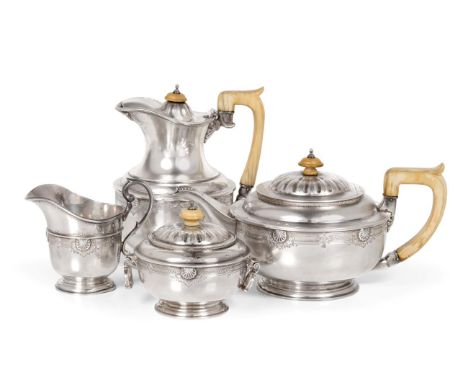 A Silver Four Piece Tea Service, Z Barraclough & Sons, London 1931, circular and of heavy gauge, decorated with an engraved a