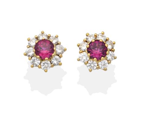 A Pair of 18 Carat Gold Ruby and Diamond Cluster Earrings, a round cut ruby within a border of round brilliant cut diamonds i