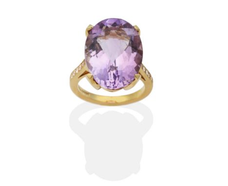 An 18 Carat Gold Amethyst and Diamond Ring, an oval cut amethyst in a claw setting, to diamond set shoulders, total estimated