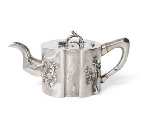 A Chinese Export Silver Teapot, mark of Pao Kuang Co, 19th century, of shaped circular naturalistic form, decorated with bran