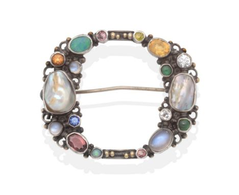 An Arts & Crafts Multi-Gemstone Brooch, an off oval frame set with vari-cut moonstone, garnet, opal, mother-of-pearl, citrine