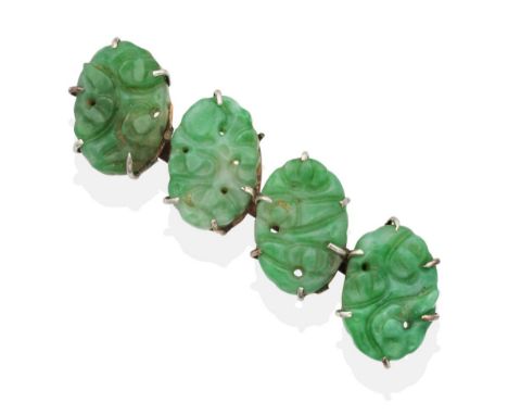 A Jade Brooch, four oval carved and pierced jade plaques in claw settings, measures 1.5cm by 5cm see illustration  One claw i