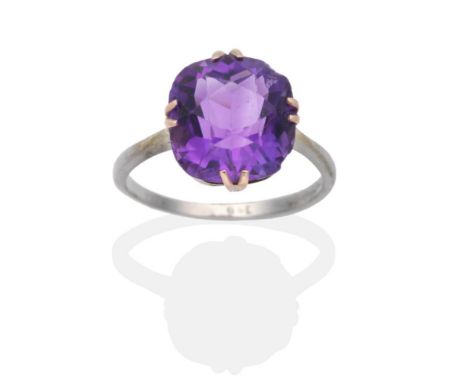 An Amethyst Ring, a cushion cut amethyst in a double claw setting, to knife edge shoulders, finger size N see illustration  .