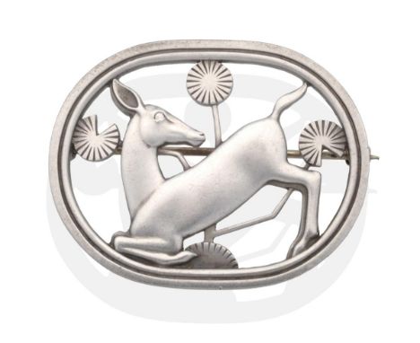 A Georg Jensen Brooch, designed by Arno Malinowski, model 256, modelled as a kneeling deer amongst leaves, within an oval fra