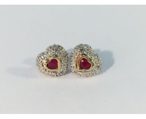 A pair of heart shaped ruby and diamond earrings