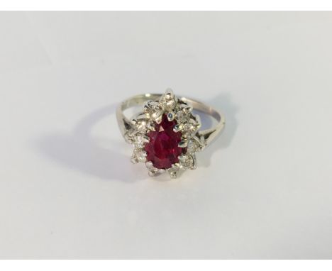 A 14k white gold pear shaped ruby and diamond ring, size L