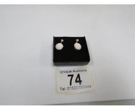 A pair of gold and opal earrings