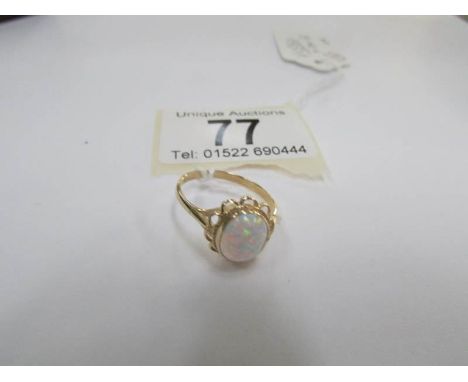 A large opal 9ct gold ring, size Q