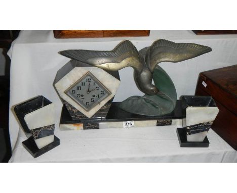 A 3 piece clock garniture in marble, the clock being surmounted seagull