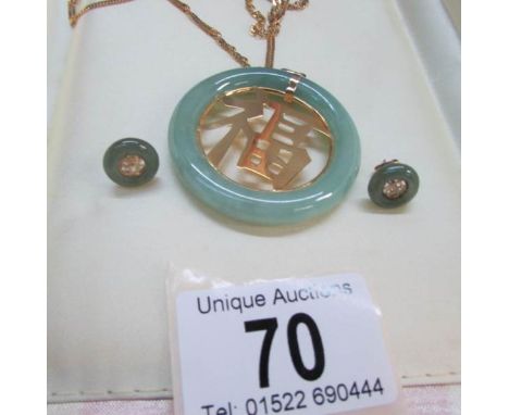 A Chinese style jade pendant on a 9ct gold chain with a pair of matching earringsAll in good condition with no damage observe