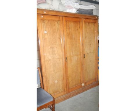 A triple door light oak wardrobe