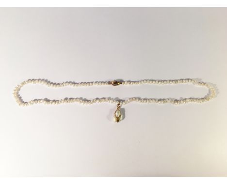 A pearl necklace with diamond set gold clasp and gold mounted drop pendant