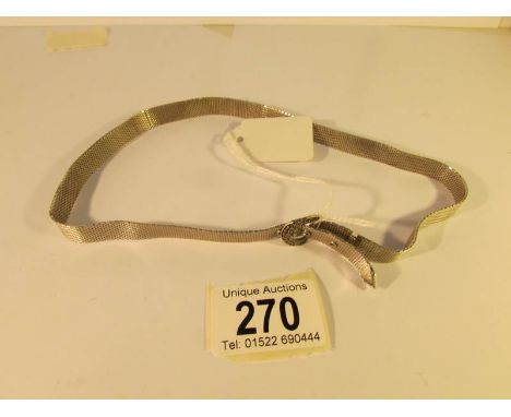 A silver necklace fashioned as a belt with buckle, engine turned