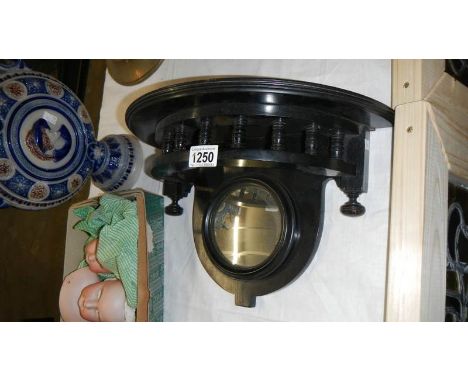 An ebonised wall bracket with mirror