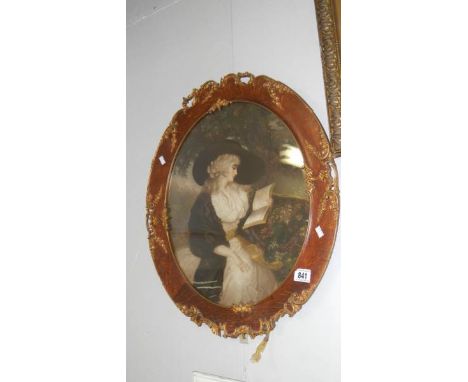 An oval ornate framed portrait
